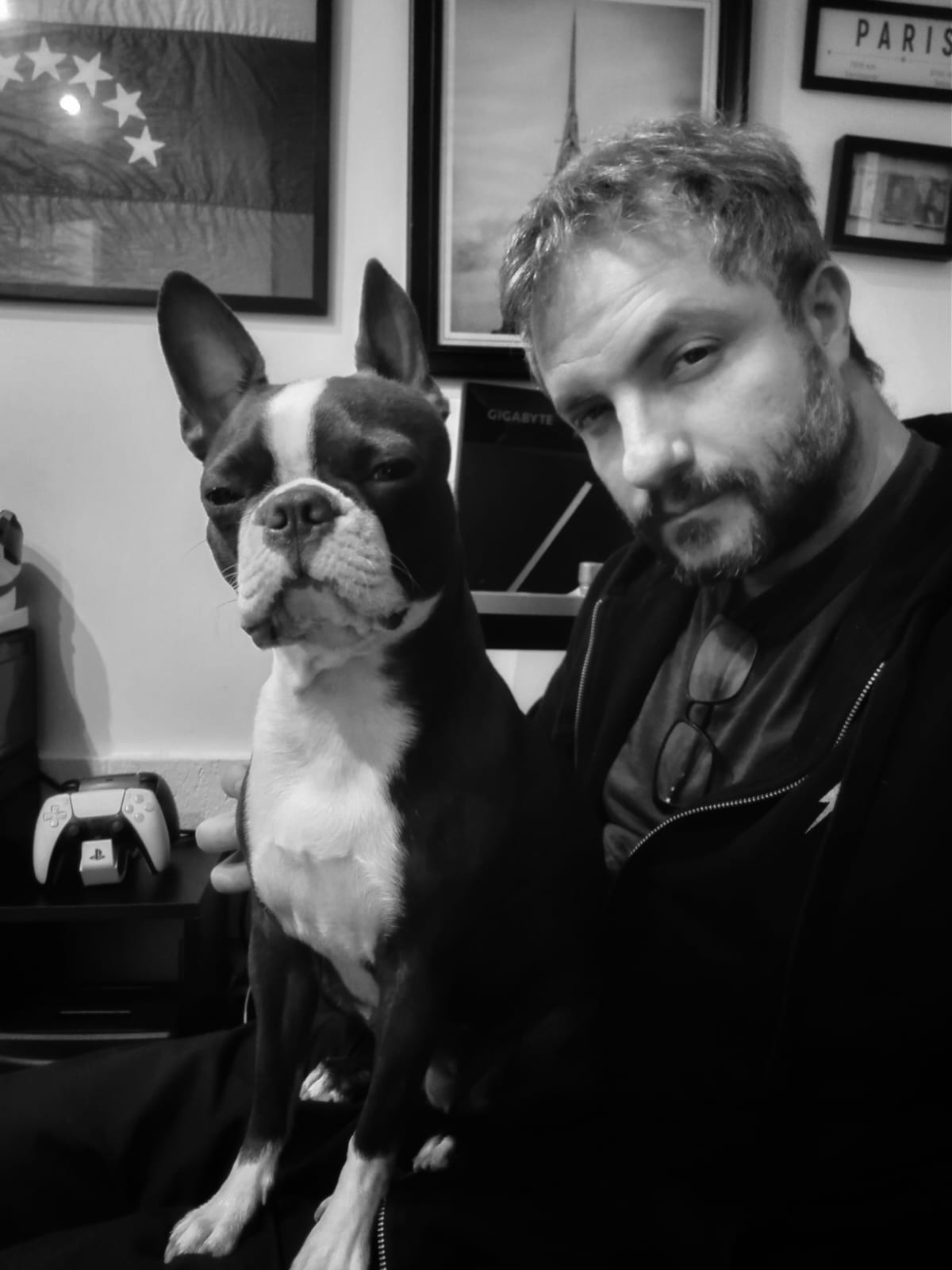 Black-and-white portrait of Nelson E. Bolivar with a dog