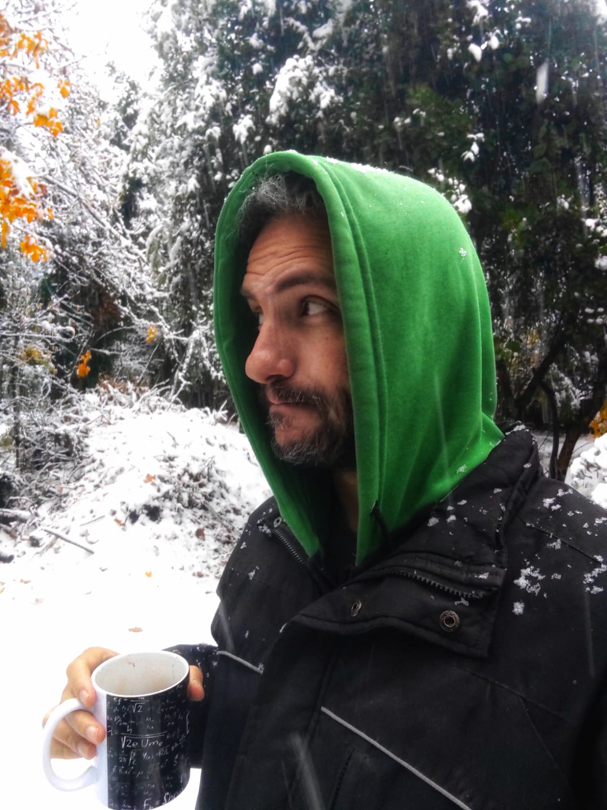 Nelson E. Bolivar holding a mug in a snowy landscape